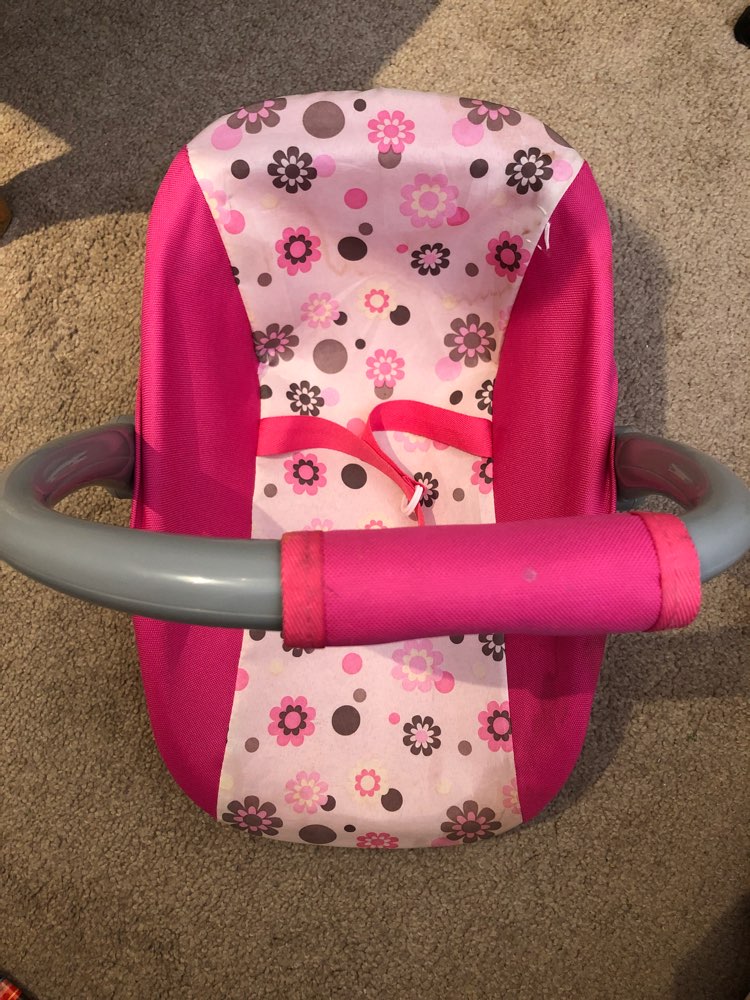 Pink plastic doll carrier with handle